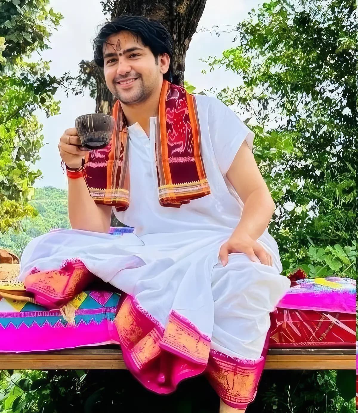 Pujya Dhirendra Krishna Shastri Ji seated outdoors